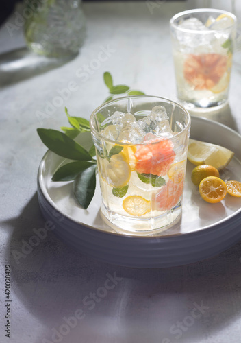 Glass of cool lemonade citrus summer fresh drink with orange, kumquat, lemon and tangerine 