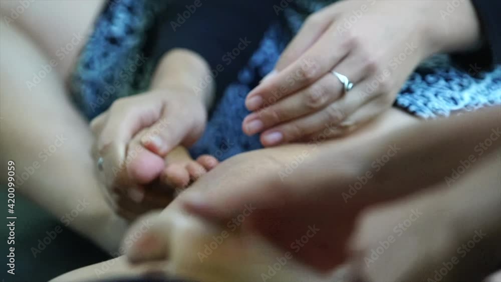 dancers knead their feet facing upward with their hands dancers knead their feet facing upward with their hands