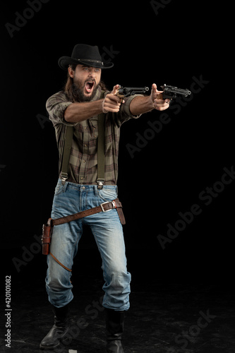 Cowboy with guns. Studio shooting © algrigo