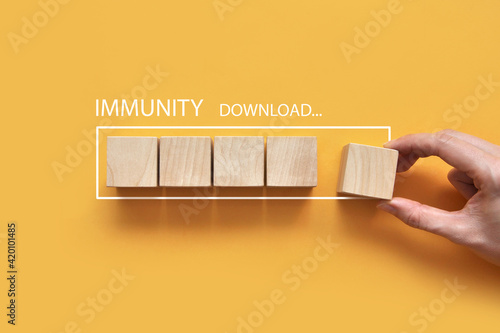 Wooden cubes and the inscription: immunity loading. A person strengthens the immune system