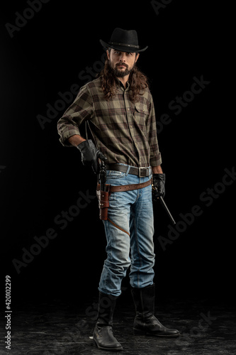 Cowboy with guns. Studio shooting