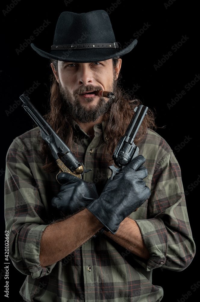 Fototapeta premium Cowboy with guns. Studio shooting