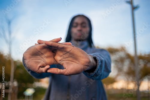 Selective focus, black woman´s hands crossed streching.