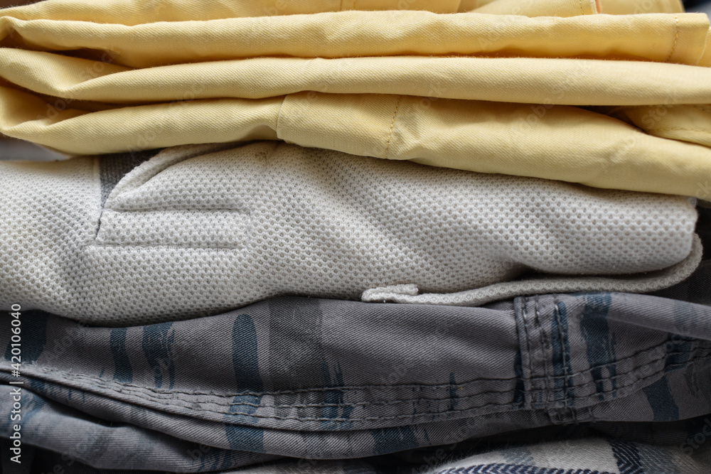 shot of Stack of folded cotton clothes in horizontal frame .Front view shot