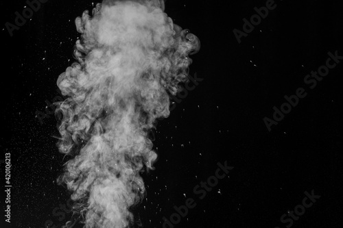 Perfect white curly steam with water drops on a black background. Abstract background, element for design