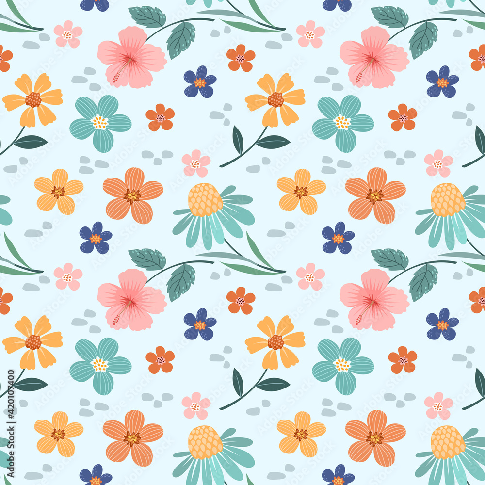 Colorful flowers, and leaves on a light blue background. Abstract floral seamless pattern design for backdrop, wrapping paper, fabric, textile, and wallpaper.