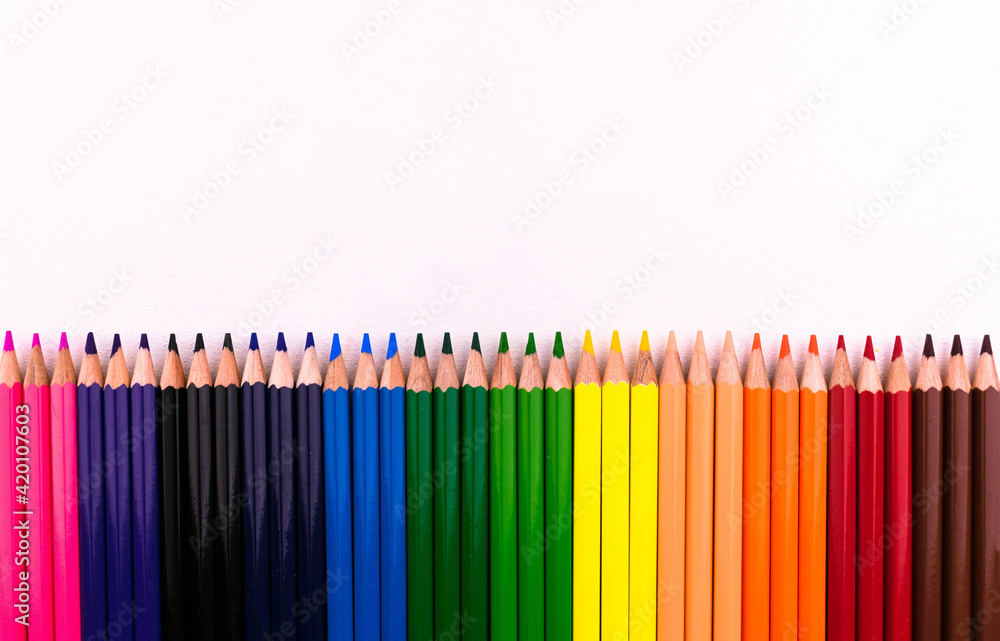 Colored pencils s row on white background.Copy space. Colored pencils s row on white background.Copy space.