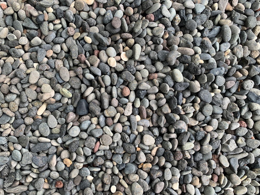 Beach stones as decoration for the front yard of the house. Gravel texture.