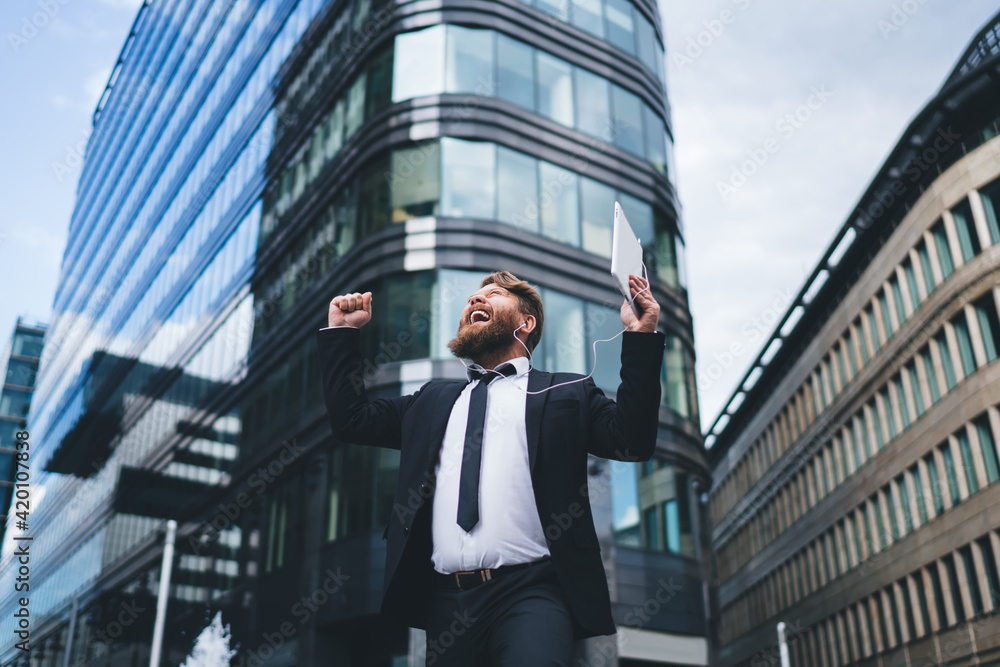 Happy businessman joying and shouting on street Happy businessman joying and shouting on street