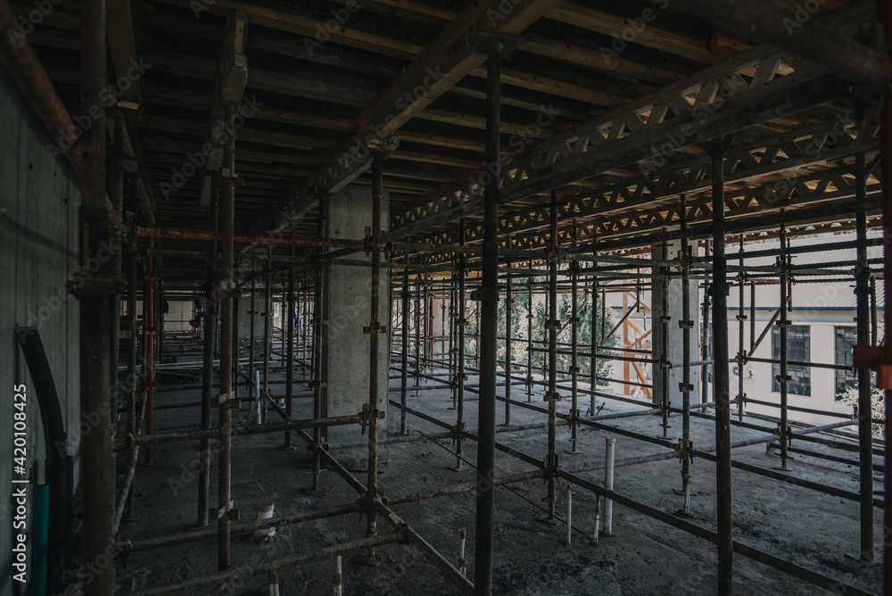 Construction site of multi-storey building with concrete slabs and columns. Men at work .