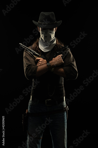 Cowboy with guns. Studio shooting