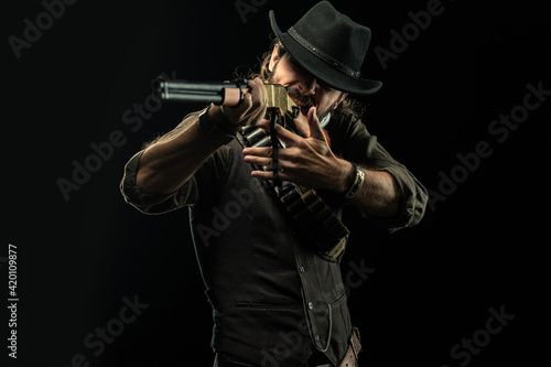 Cowboy with guns. Studio shooting