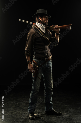 Cowboy with guns. Studio shooting