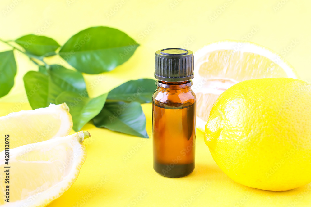 Lemon oil on a bright background and yellow citrus fruits. Aromatherapy, aroma. The use of oil in medicine. Lemon oil on a bright background and yellow citrus fruits. Aromatherapy, aroma. The use of oil in medicine.