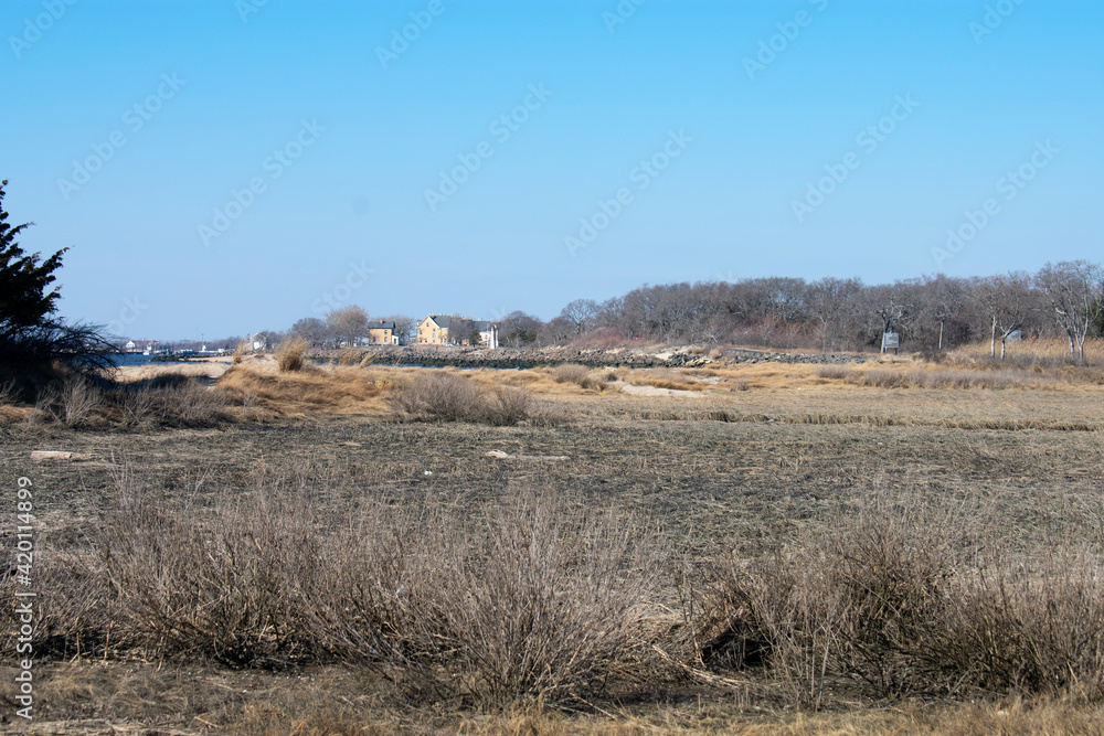 Sandy Hook Bay marshlands with the officer's row buildings showing in the distance -05