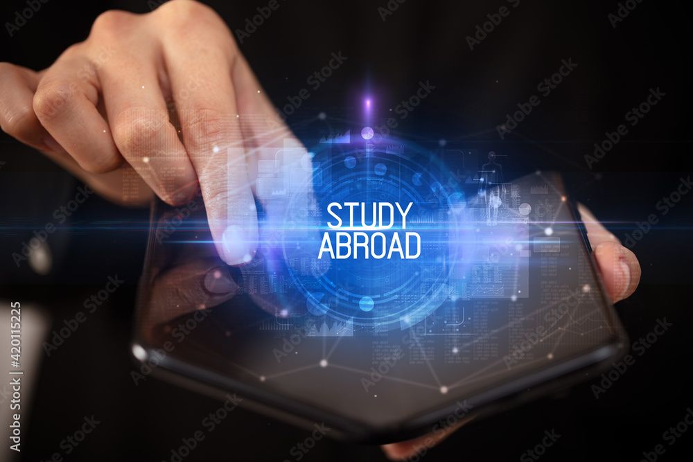 Young man holding a foldable smartphone Young man holding a foldable smartphone