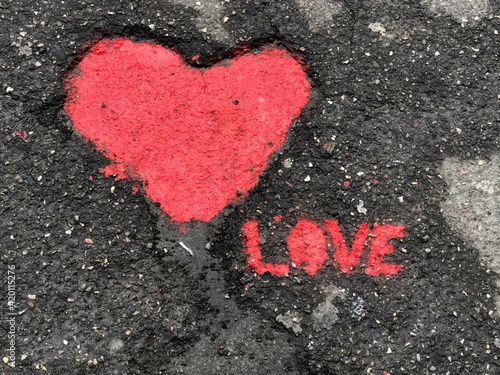 red heart on asphalt