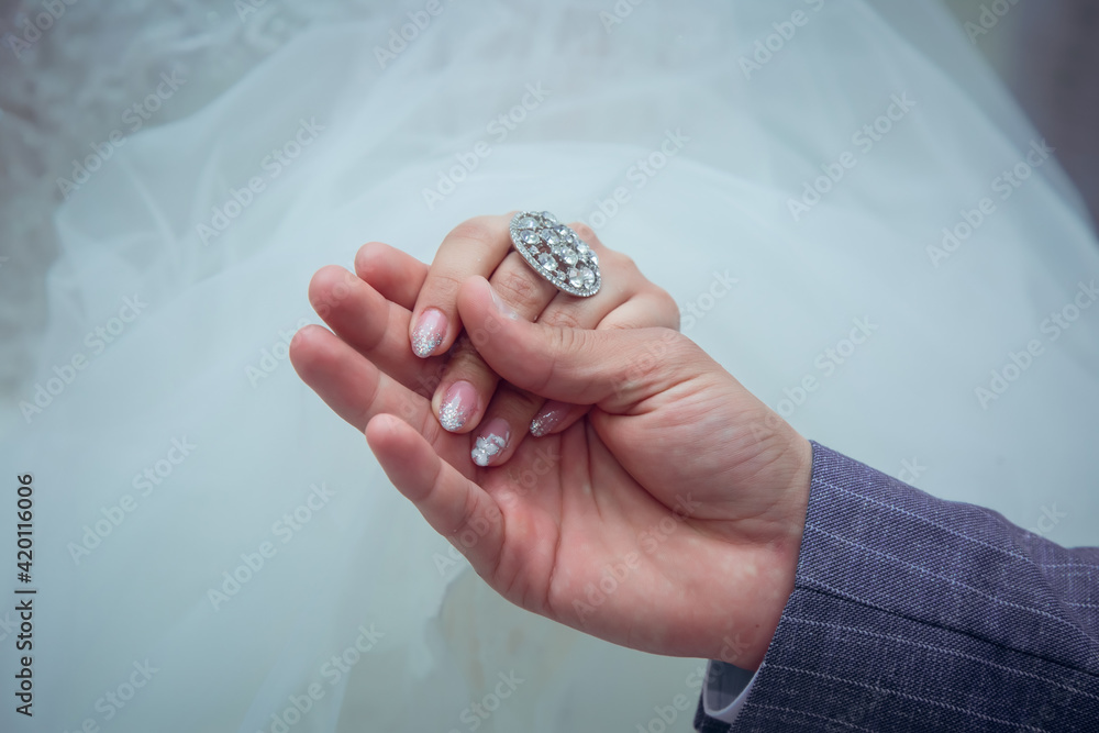 the guy holds the hand of his bride the guy holds the hand of his bride