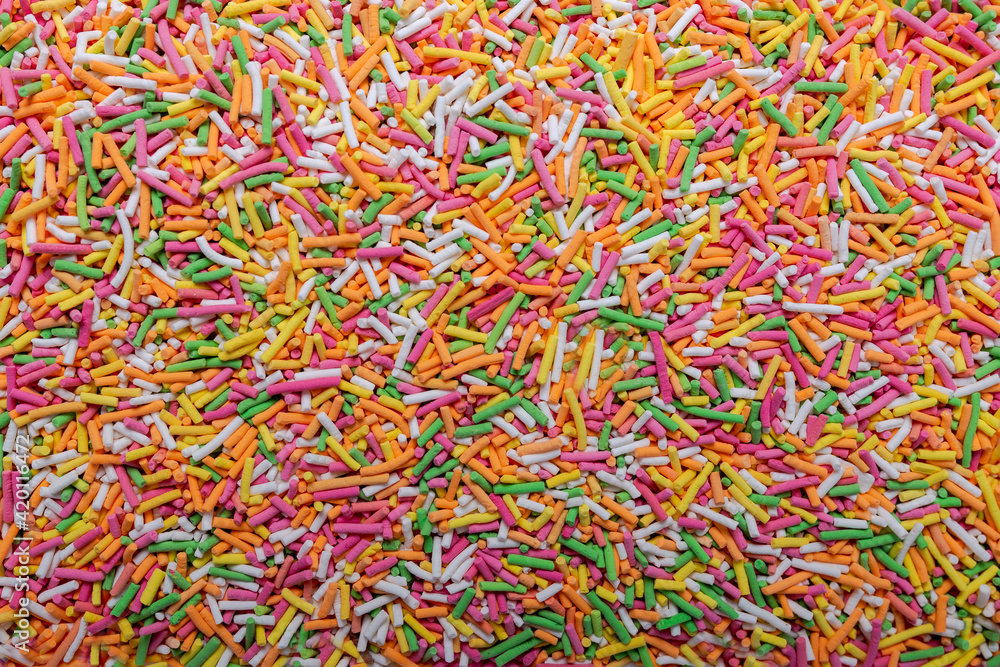 Background and texture from colorful cake decorations. 
Colorful sprinkles background, decoration for cake and bakery.