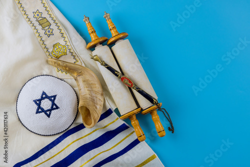 Jewish holidays, during prayer items kippa with prayer shawl tallit on shofar, torah scroll photo