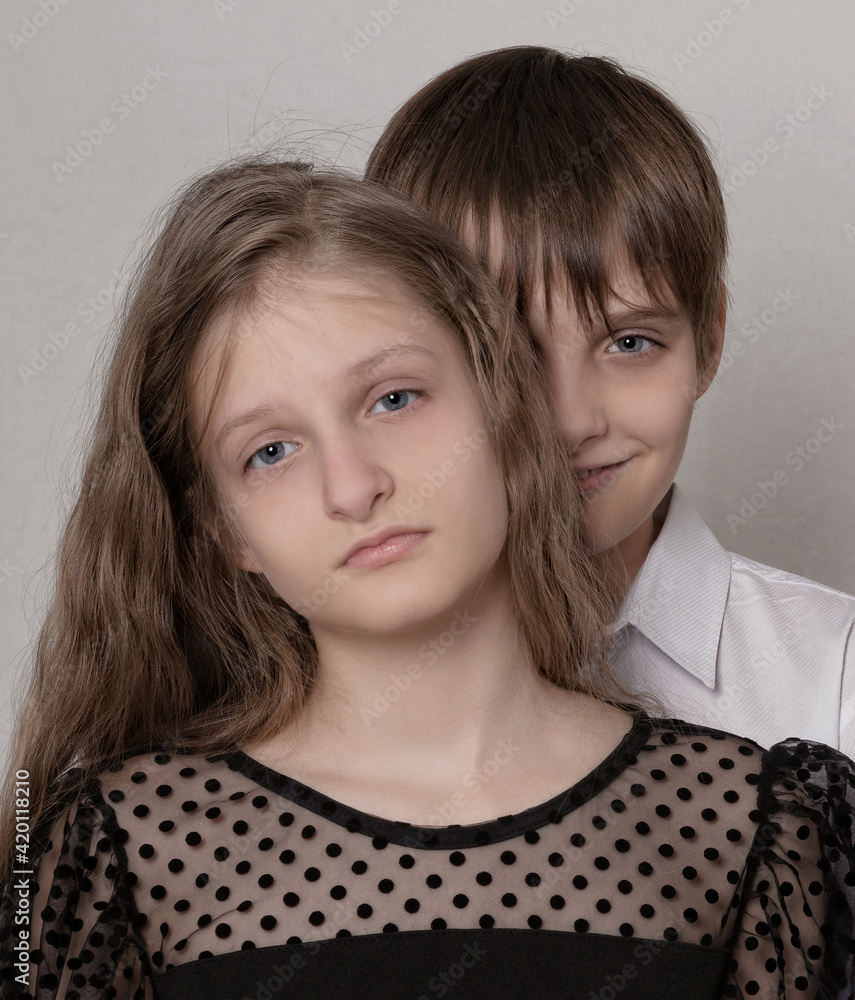 Portrait of teenagers standing against gray background Portrait of teenagers standing against gray background