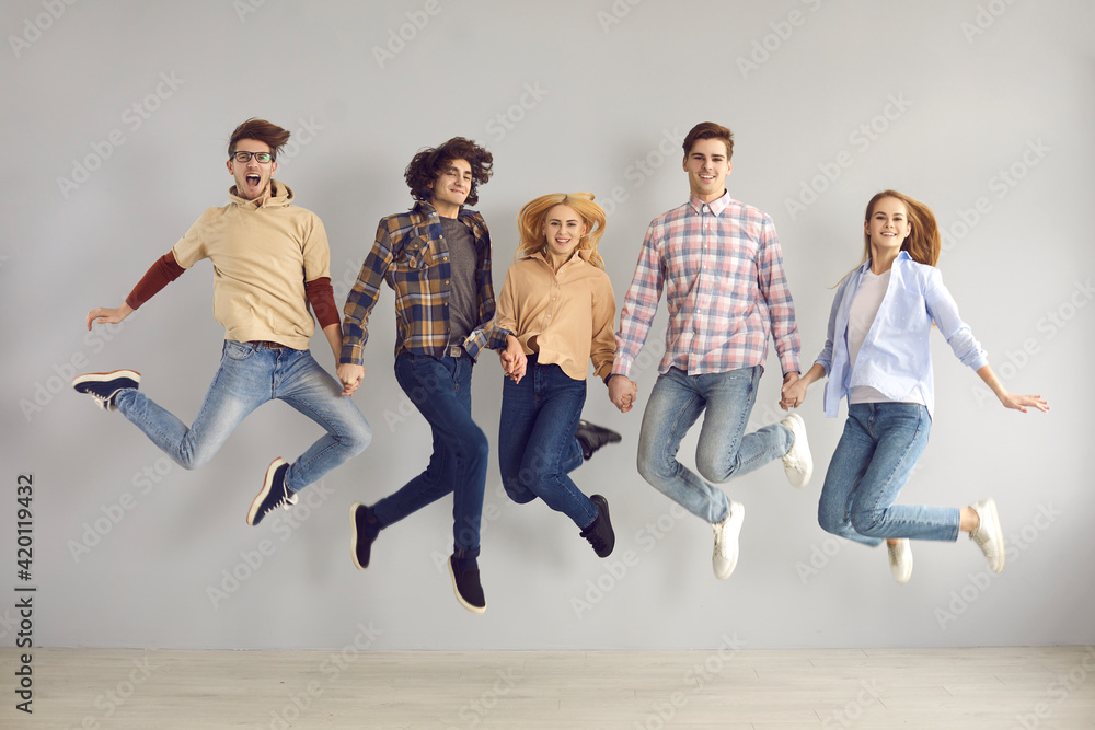Naklejka premium Full-length studio portrait of enthusiastic caucasian european teenager jumping high rejoicing start of holidays, end of academic year or quarantine, getting education grant or admission to university