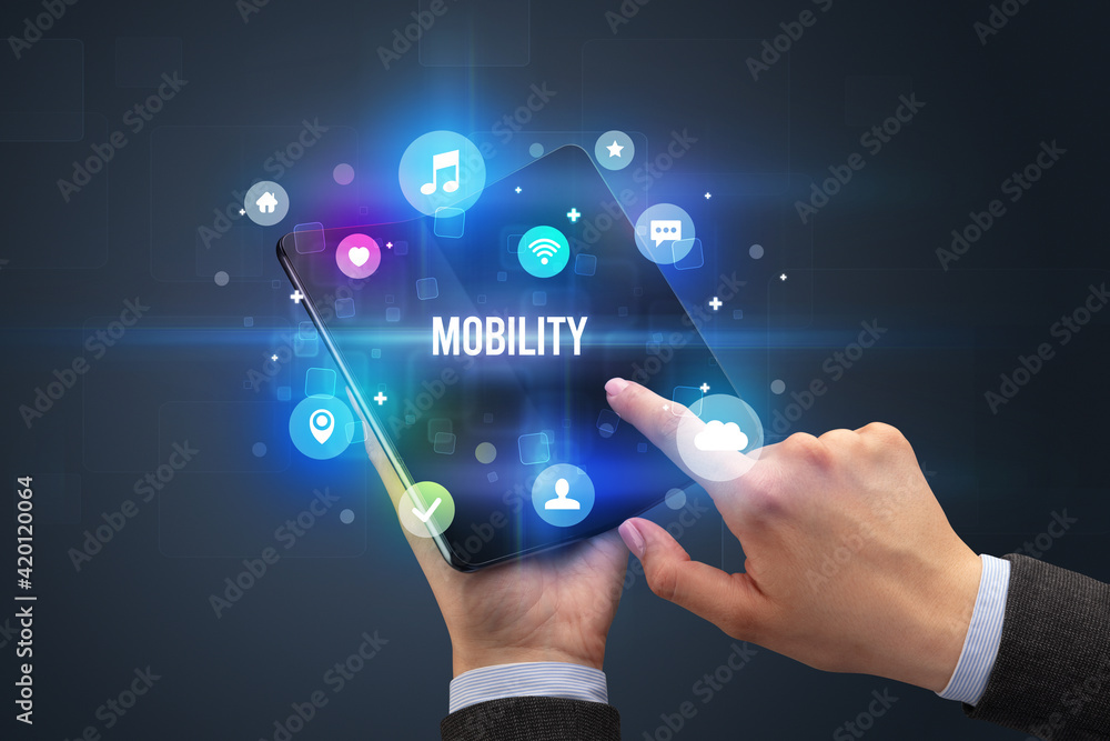 Fototapeta premium Businessman holding a foldable smartphone