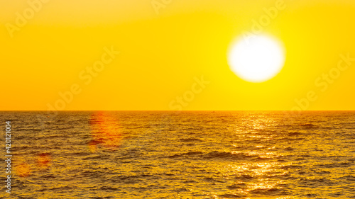 Orange sunset over sea. Bright sun over the sea horizon. Concept: vacation and relax