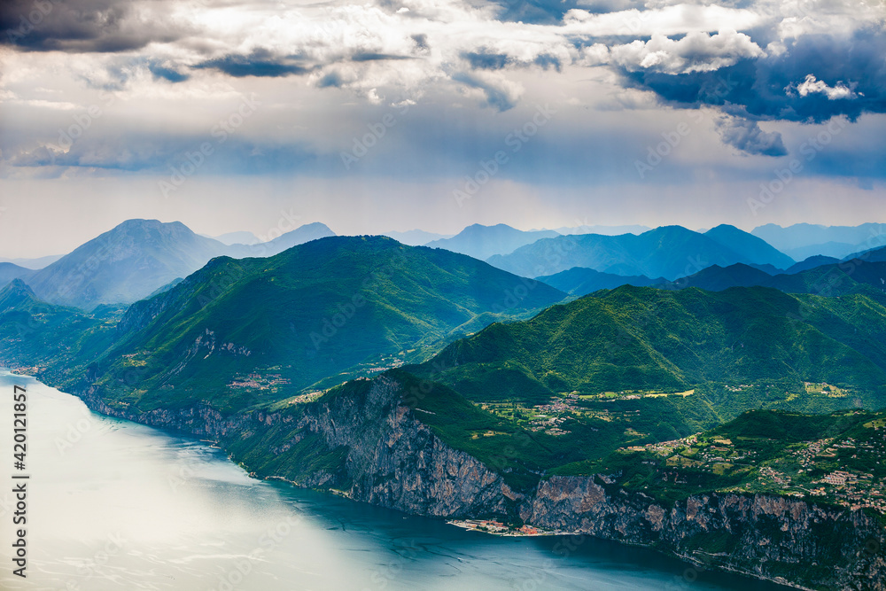 View of Garda lake and surrounding mountains with impressive clouds