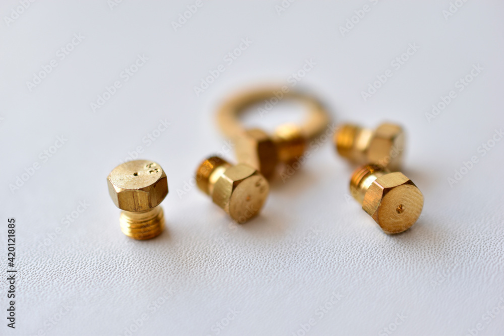 Golden gas burner nozzle bolt on white background Golden gas burner nozzle bolt on white background