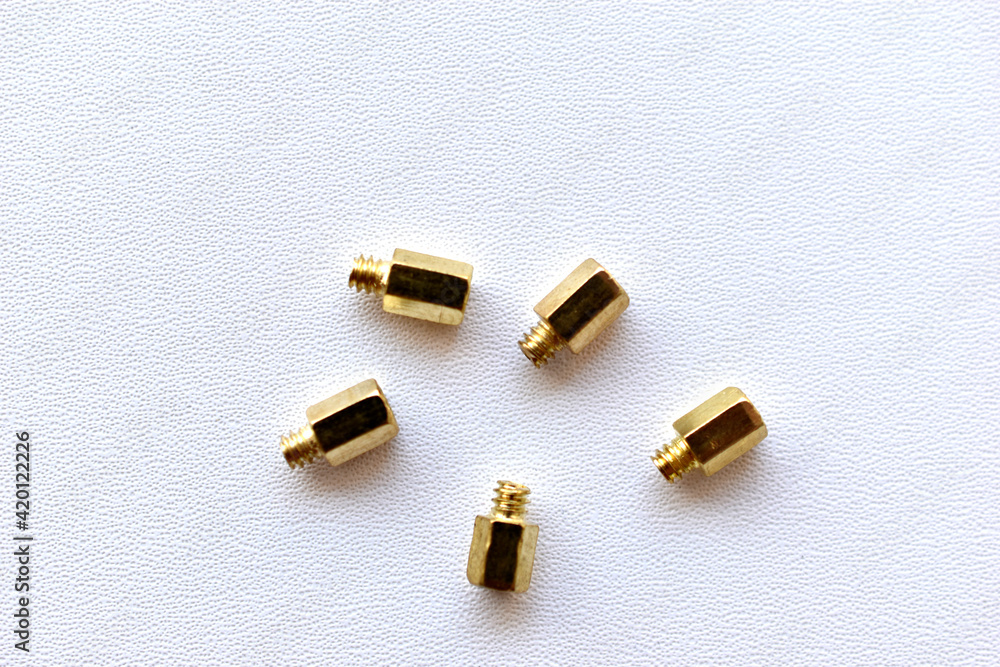 Yellow and copper PC bolts on white background Yellow and copper PC bolts on white background