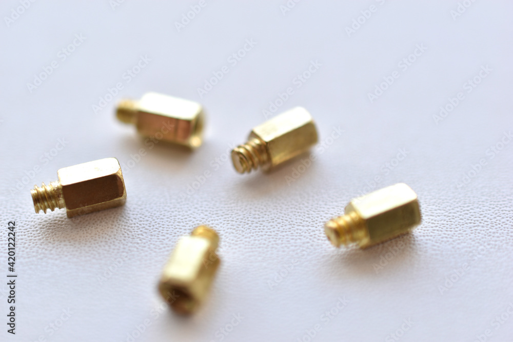 Yellow and copper PC bolts on white background Yellow and copper PC bolts on white background