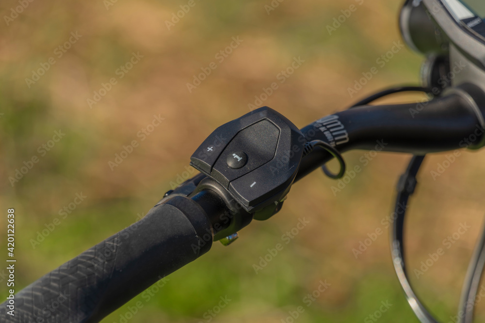 Black and gray electric bicycle in sunrise morning time on frosty field Black and gray electric bicycle in sunrise morning time on frosty field