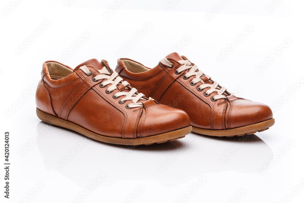 Pair of brown leather men's shoes on a white background.