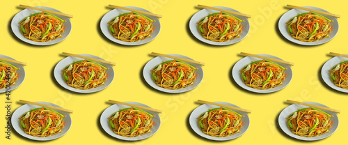 Pattern on a yellow background, wok noodles in a plate with chopsticks, minimalistic banner, background for design.