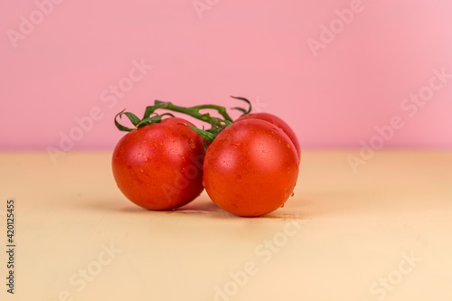 A bunch of tomatoes on a colored background