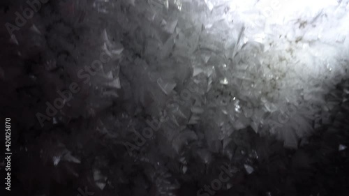 In the mountains inside the Bogdanovich glacier, in an ice cave. Snow and ice of interesting shapes grow on the walls of the cave. Stalactites hang. Huge ice walls and rocks. Sometimes macro. Almaty photo