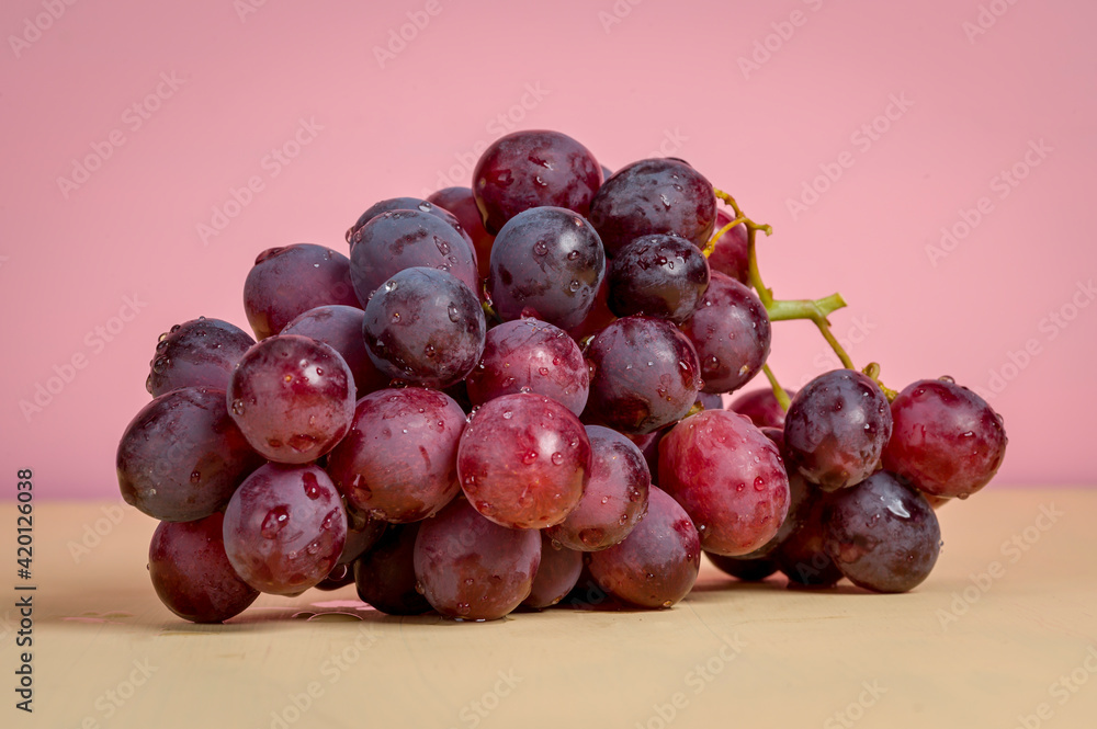 A bunch of grapes on a colored background A bunch of grapes on a colored background