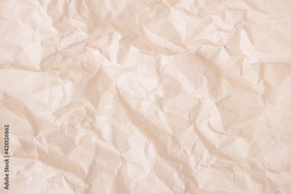 Obraz premium Craft paper. Header, banner for site design. Beige crumpled paper background. Empty space for text. Flat lay top-down. Crumpled paper sheet with copyspace for text as template food background.