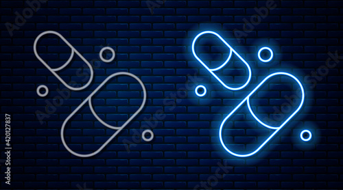 Glowing neon line Vitamin complex of pill capsule icon isolated on brick wall background. Healthy lifestyle. Vector