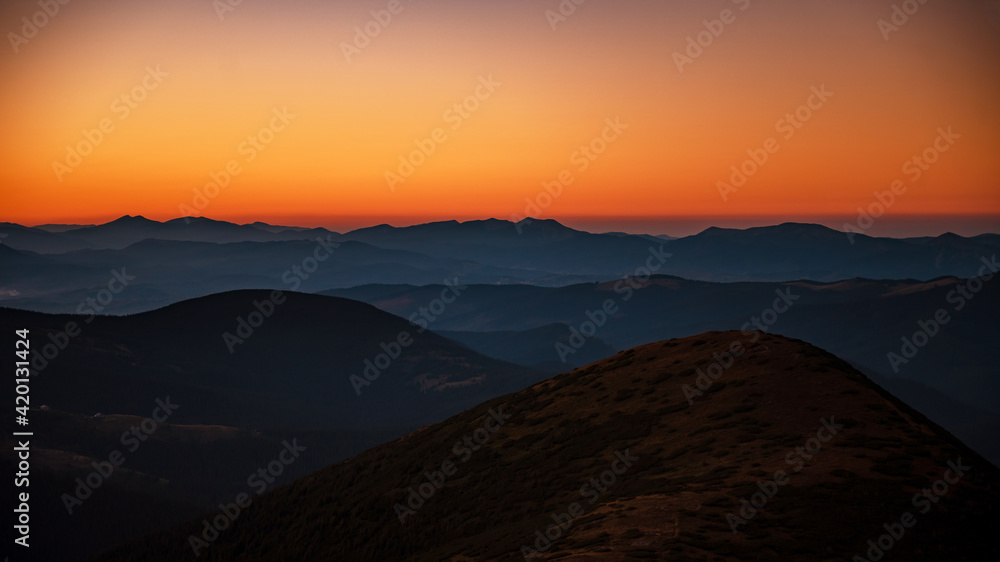 Mountain landscape with colorful sky during sunset
