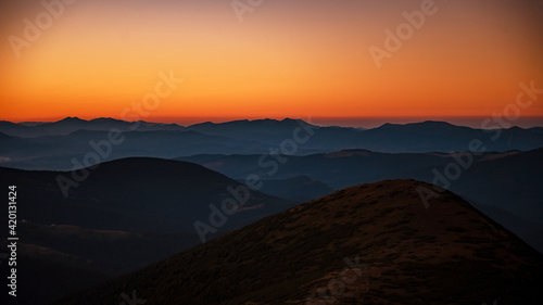 Mountain landscape with colorful sky during sunset © WellStock