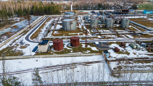 Aerial view of the vast territory of a large industrial asphalt plant with high pipes. Environmental pollution. Industrial area. Bitumen Storage Facility.