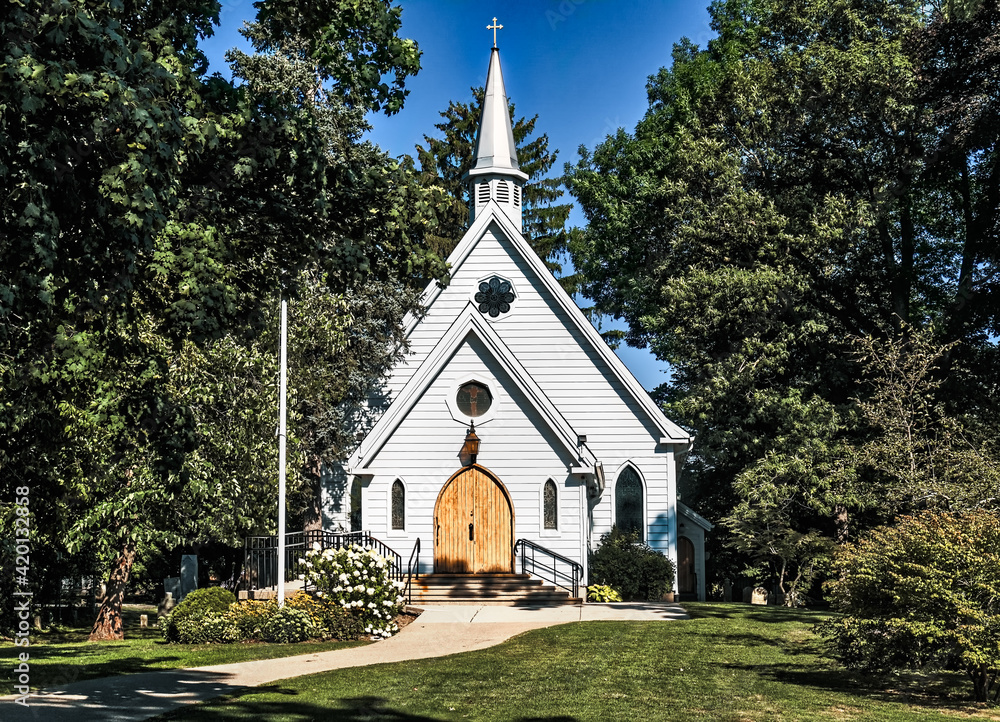 Historic St. Luke's Anglican church in Burlington, Ontario, Canda sits on beuatifully manicured cemetery grounds on a sunny summer's day