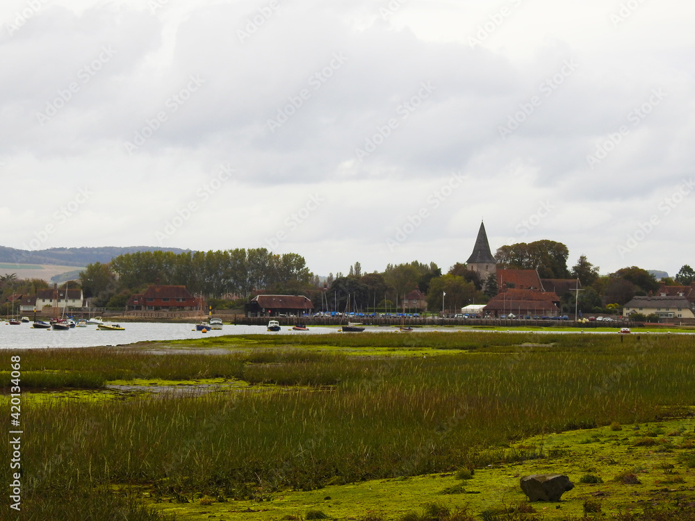 Flooding area with low green vegetation, water ,buildings and boats Flooding area with low green vegetation, water ,buildings and boats
