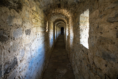 Old narrow warm stone tunnel in a medieval castle