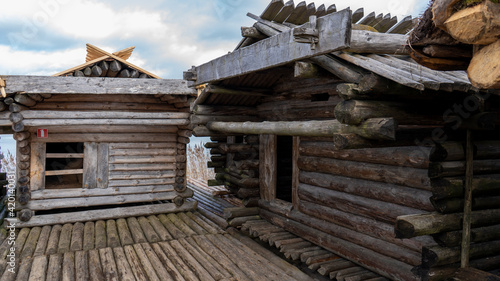 Araisi Lake Castle in Latvia. Historical Wooden Buildings on Small lake Island in the Frozen Lake Araisi in the Winter. Reconstruction of Wooden Fortified Settlement of Ancient European People © Uldis