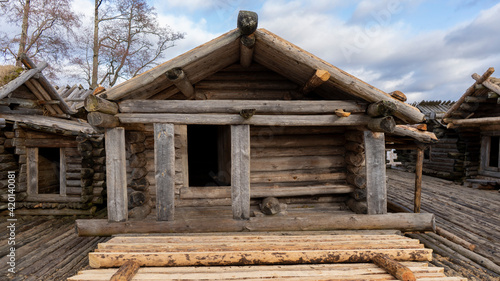 Araisi Lake Castle in Latvia. Historical Wooden Buildings on Small lake Island in the Frozen Lake Araisi in the Winter. Reconstruction of Wooden Fortified Settlement of Ancient European People © Uldis