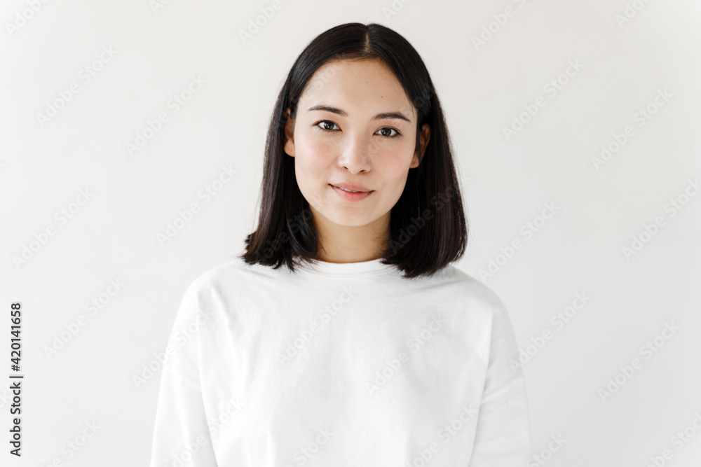 Young brunette woman over isolated white background. Girl looking at the camera Young brunette woman over isolated white background. Girl looking at the camera
