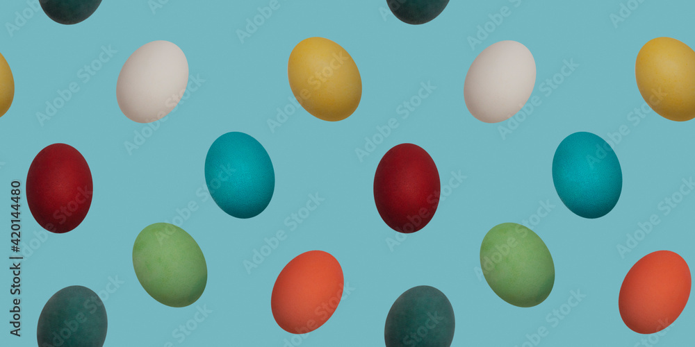 Seamless repeating pattern. Colorful chicken boiled eggs on a blue background turned in different directions. The concept of Easter wallpaper for advertising, greeting cards and editing. Seamless repeating pattern. Colorful chicken boiled eggs on a blue background turned in different directions. The concept of Easter wallpaper for advertising, greeting cards and editing.